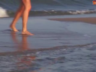 Busty milf squirts on the beach